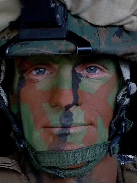 A U.S. service member in helmet and camouflage face paint — the military background behind Veteran Handyman, LLC