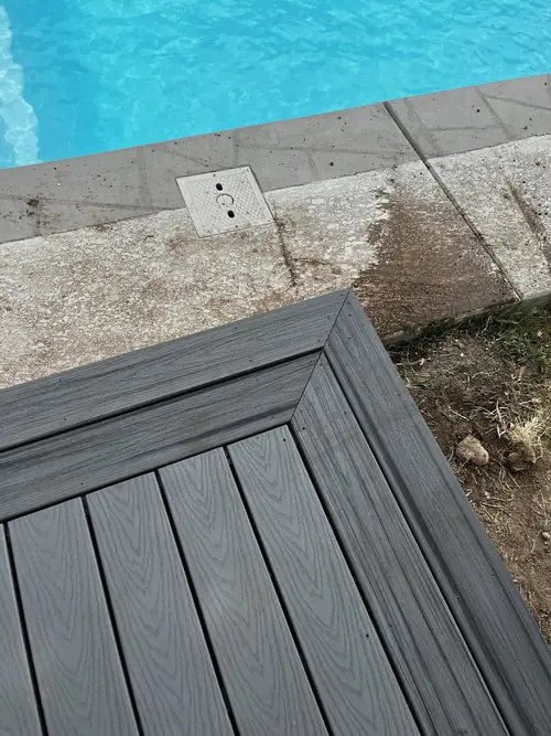 Detail of mitred composite decking boards meeting the pool coping