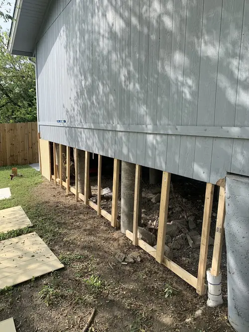 New framing and siding repair along a raised pier-and-beam foundation