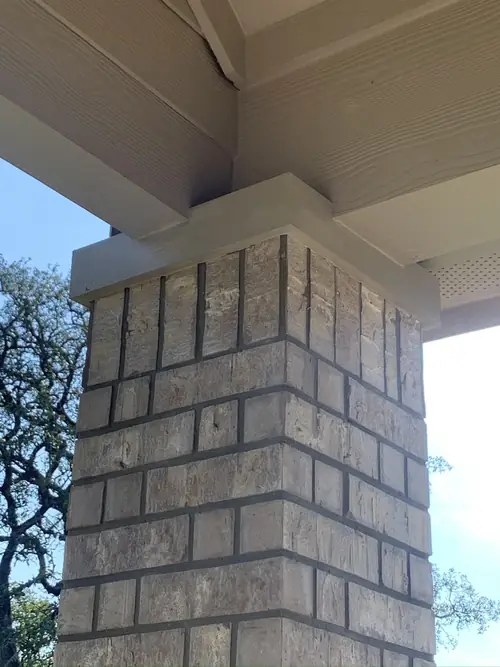 Stone column and beam detail under a covered porch
