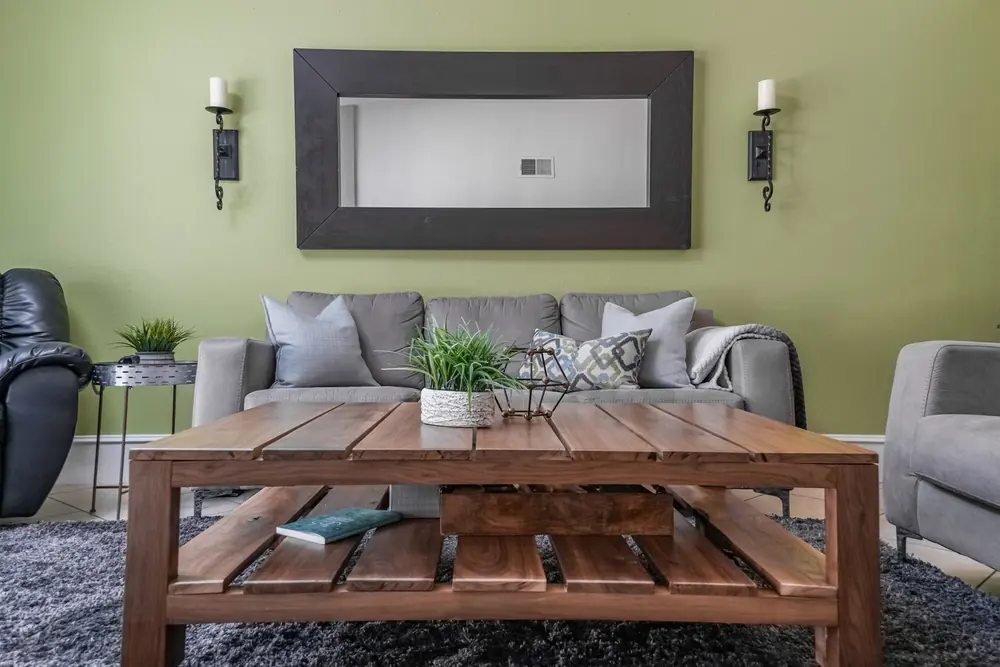 A custom-built hardwood coffee table finished and placed in a client's living room