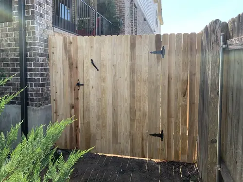 New cedar privacy fence and matching gate hung on black strap hinges